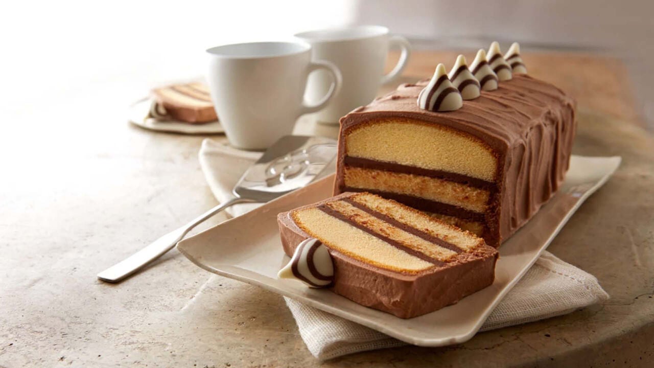 slicing hersheys hugs and kisses pound cake into pieces for serving