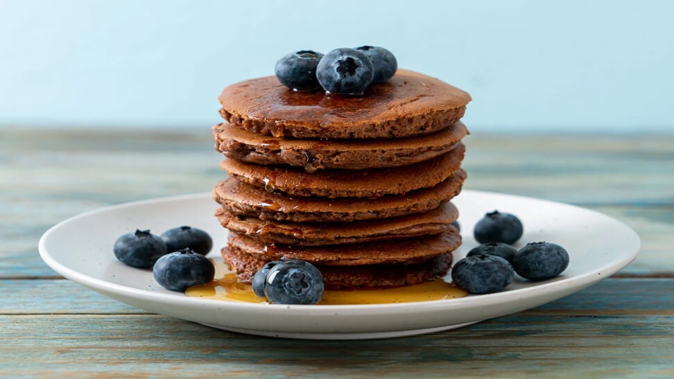 plate of lilys and hersheys keto chocolate chip pancakes topped with blueberries