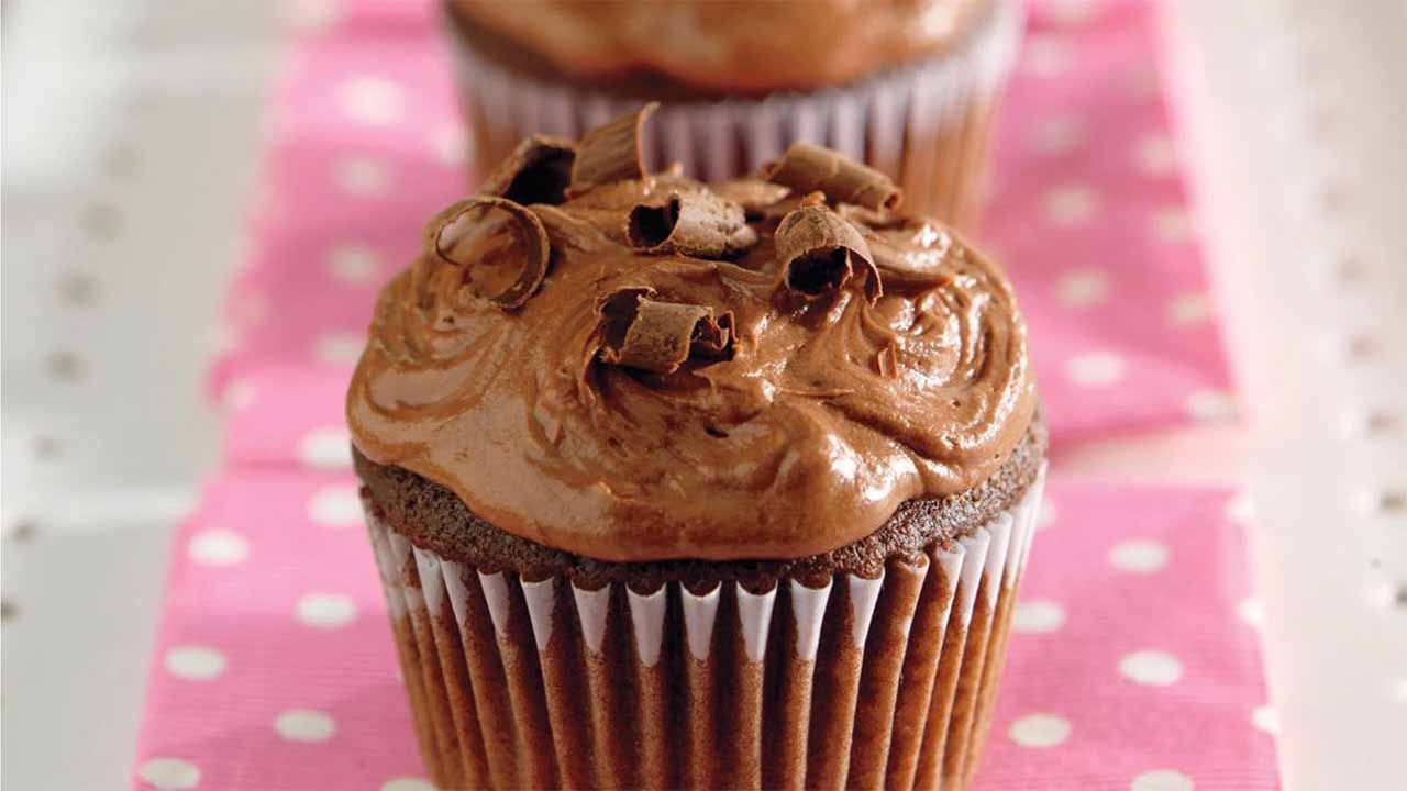 iced double chocolate cupcakes topped with chocolate shavings