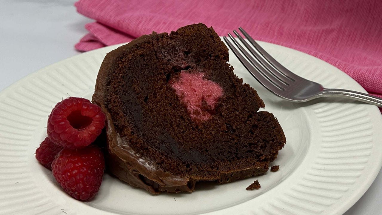 slice of chocolate raspberry bundt cake with raspberry reduction filling