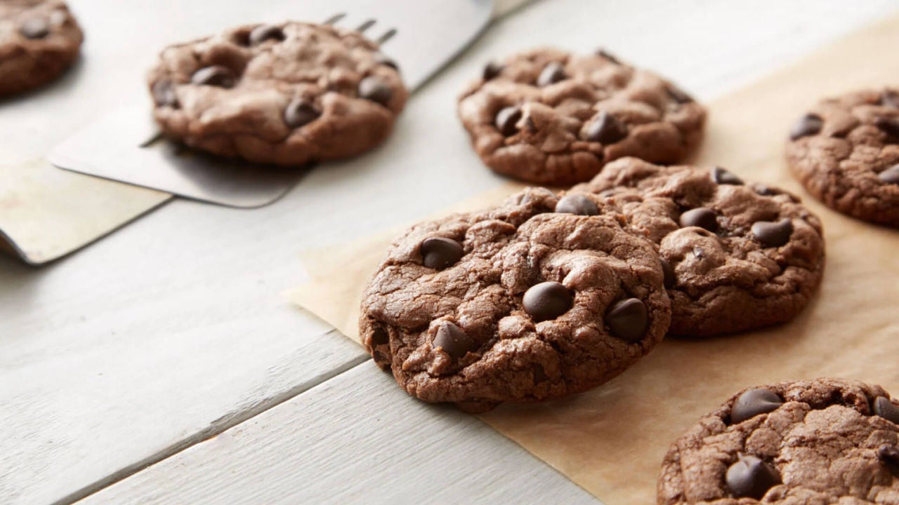 batch of chewy brownie cookies on parchment paper