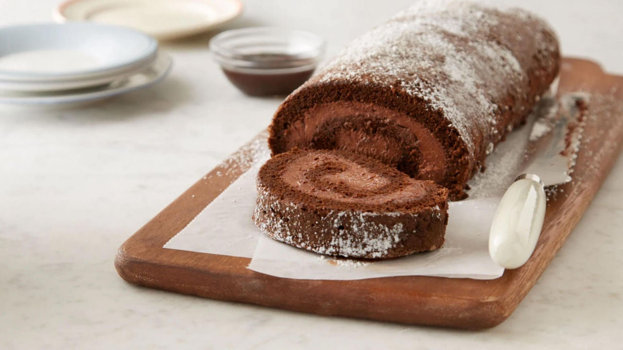 slicing up a chocolate mousse cake roll