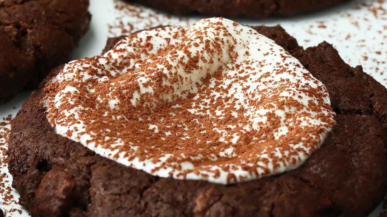 batch of hot cocoa cookies topped with a sprinkle of cocoa powder