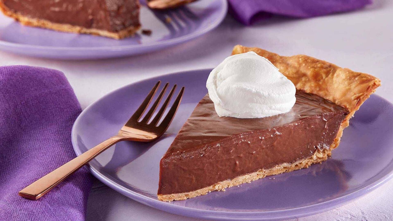 slice of hersheys cocoa cream pie topped with whipped cream