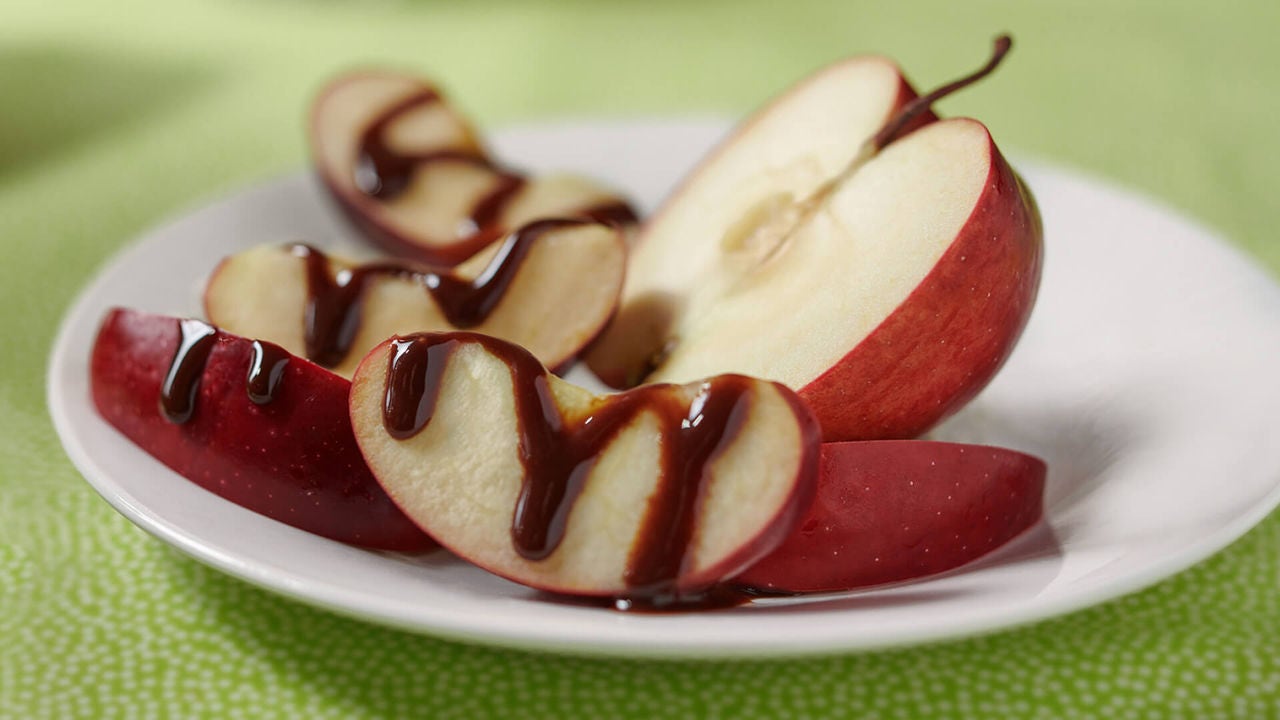 apple cut into slices and drizzled with hersheys chocolate syrup