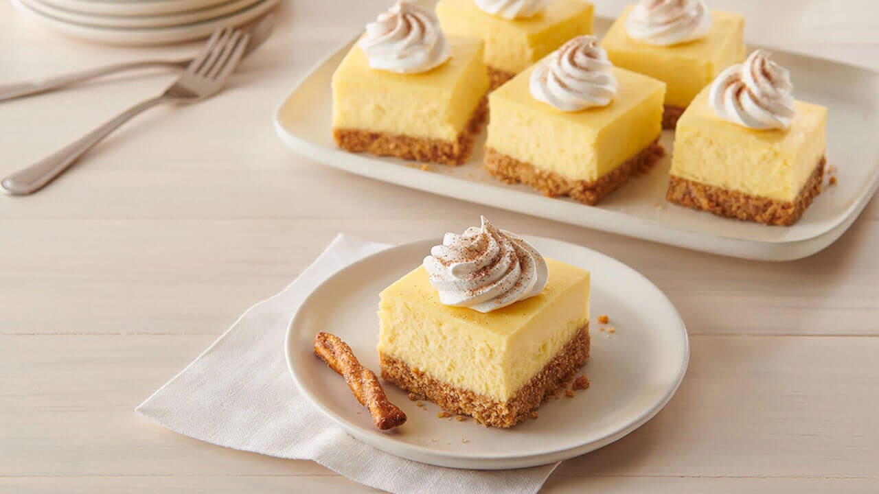 tray of cheesecake bars with dots cinnamon sugar pretzel crust