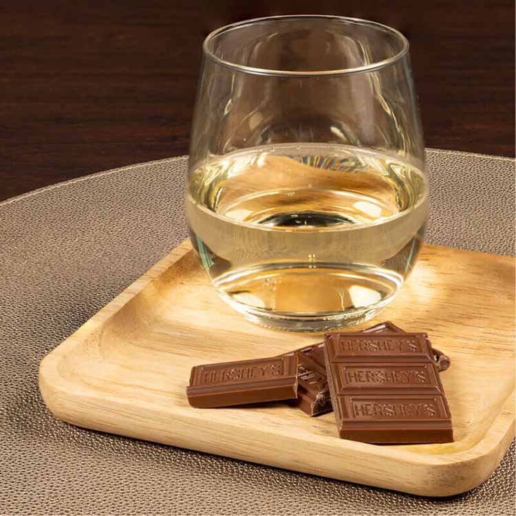 glass of riesling paired with hersheys milk chocolate candy