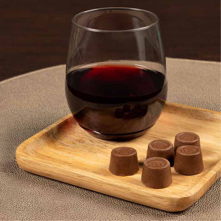 glass of pinot noir paired with rolo creamy caramels in rich chocolate candy