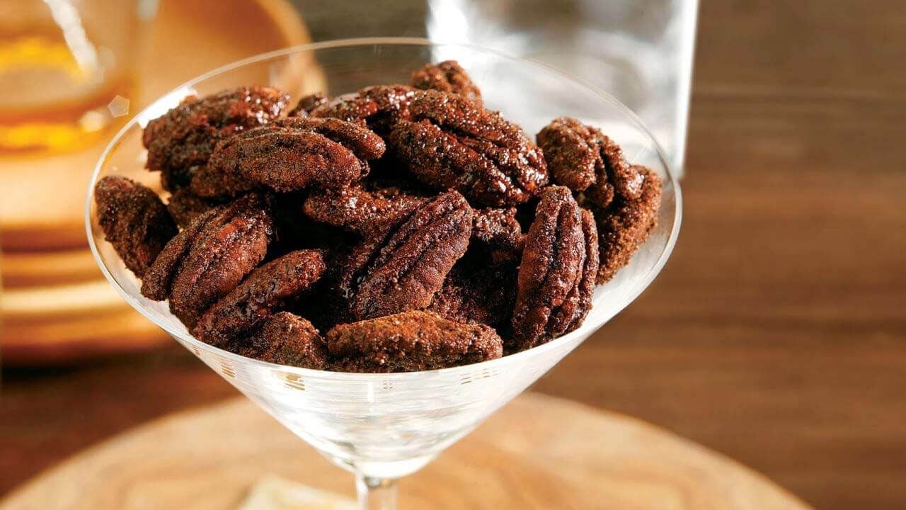 glass filled with spicy glazed pecans