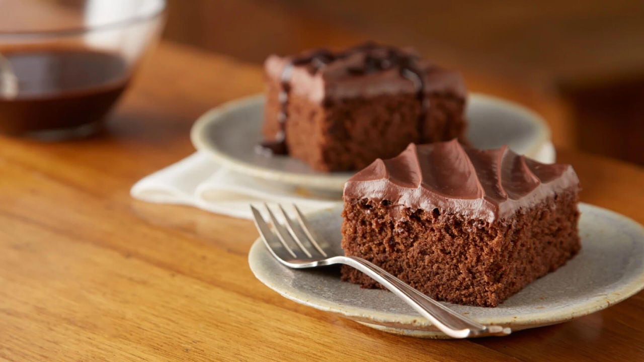 two plated squares of iced one bowl chocolate cake