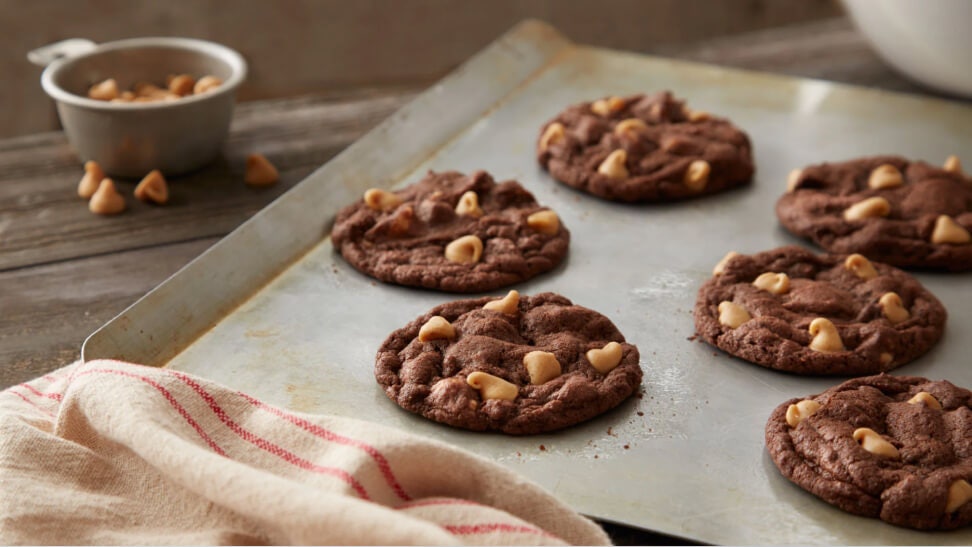 tray of freshly made reeses chewy chocolate cookies with peanut butter chips