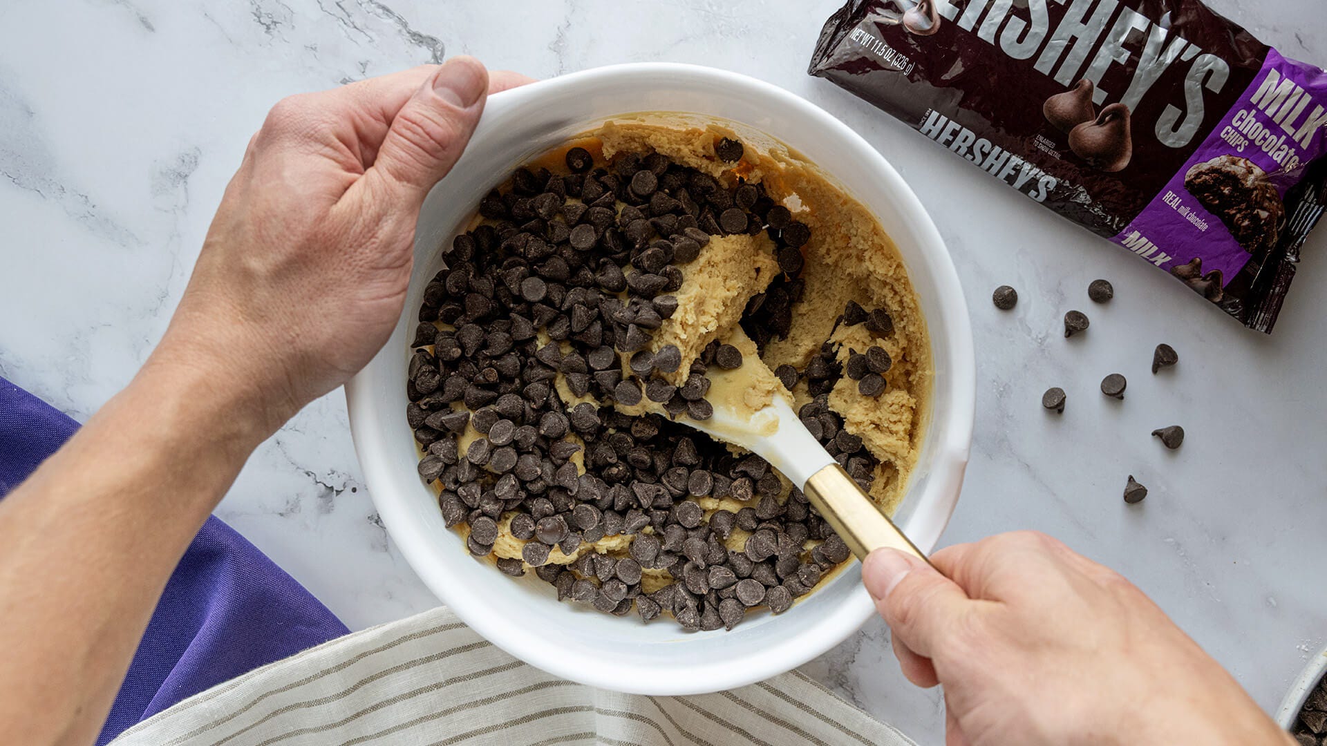 stirring chocolate chips into cookie mix