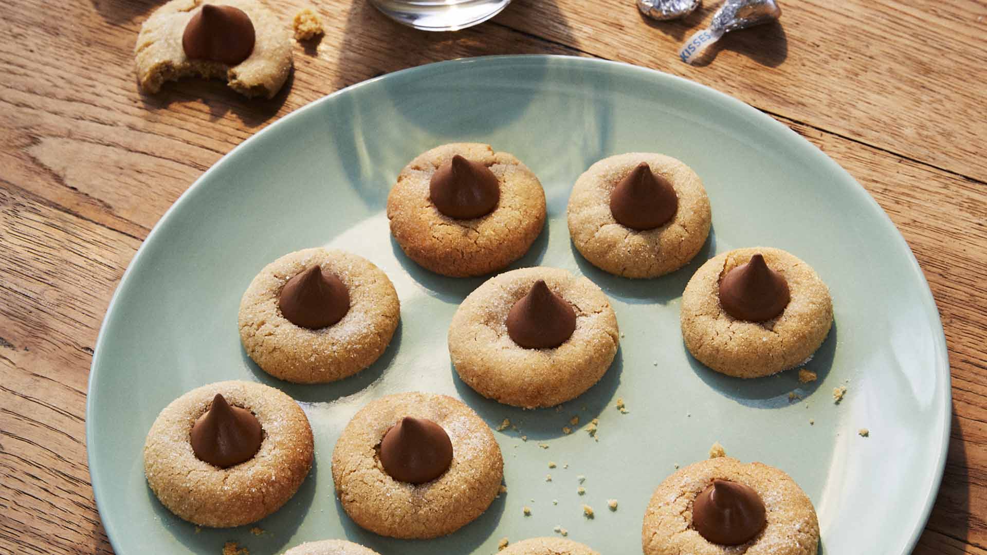 batch of freshly made peanut butter blossoms on serving dish