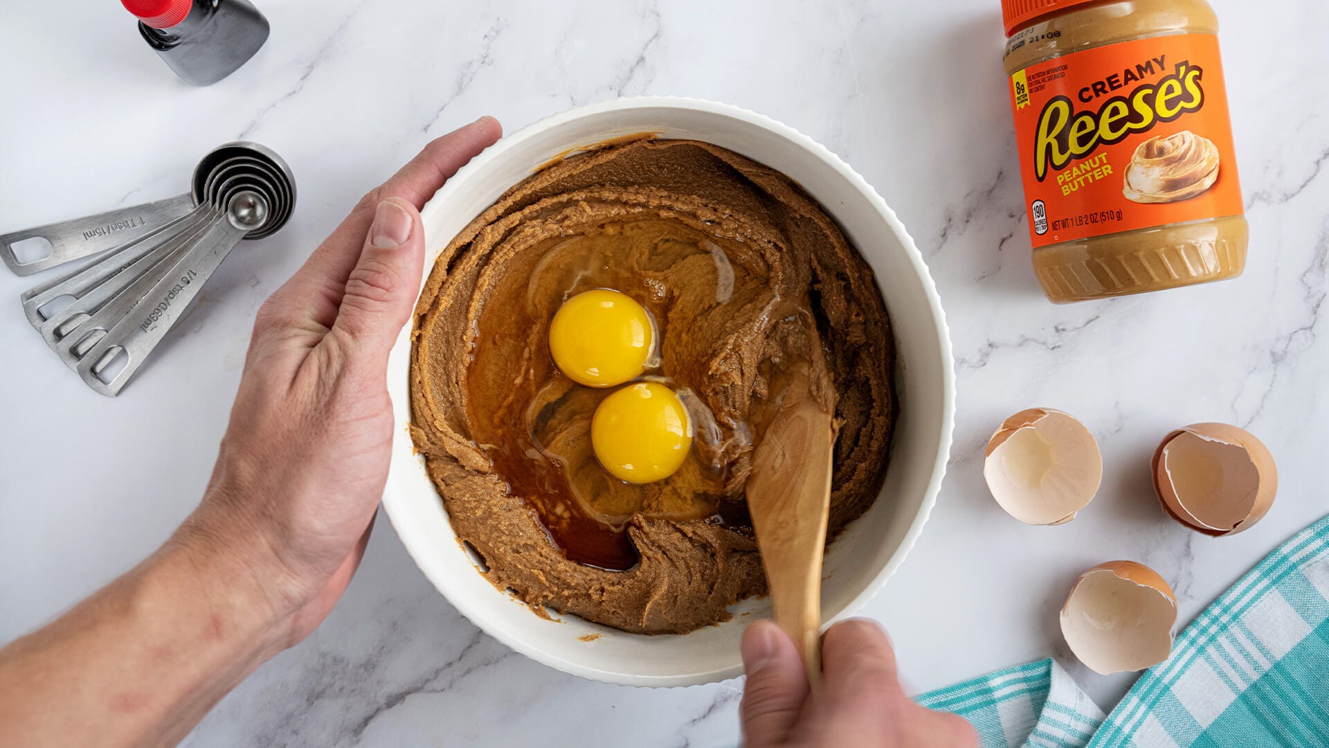 adding eggs to cookie dough