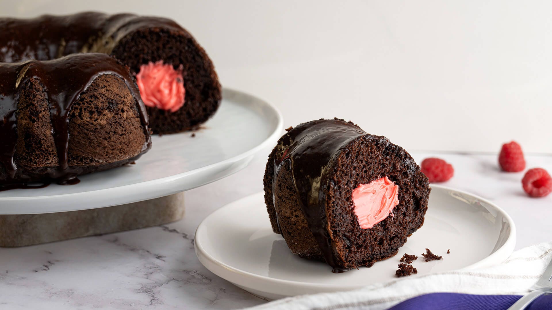 slice of hersheys chocolate raspberry creme bundt cake on a serving dish