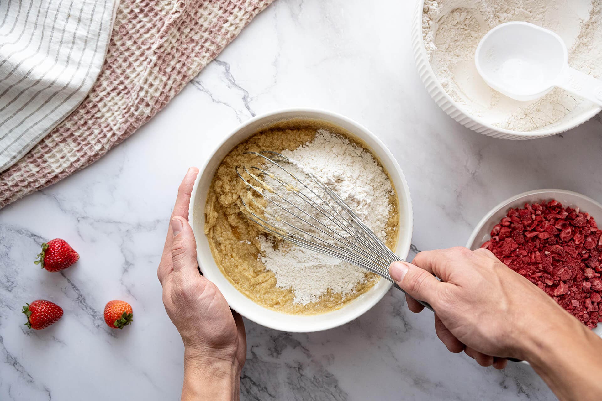 flour, baking soda, and salt being mixed into dough