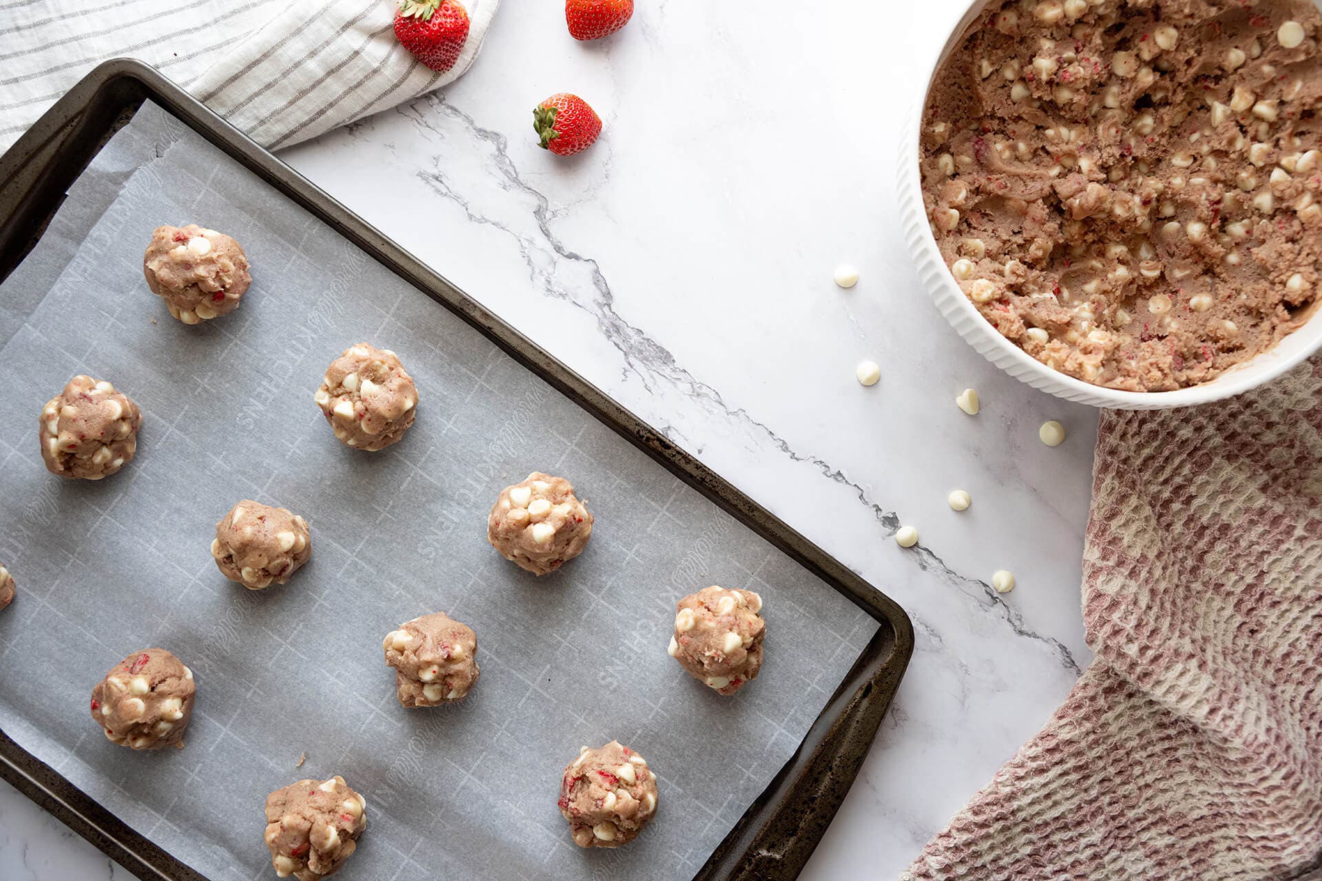 cookie dough balls placed on baking sheet