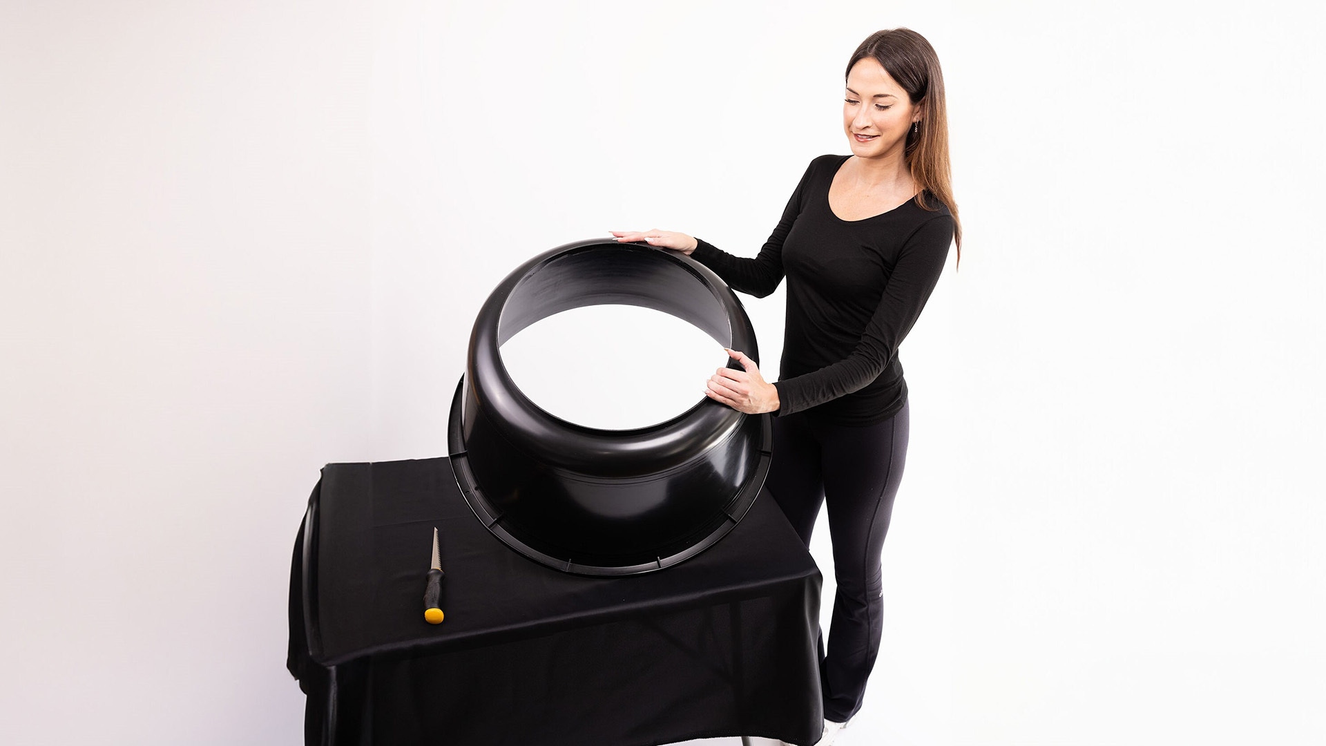 woman holding large bowl that has the bottom cut off