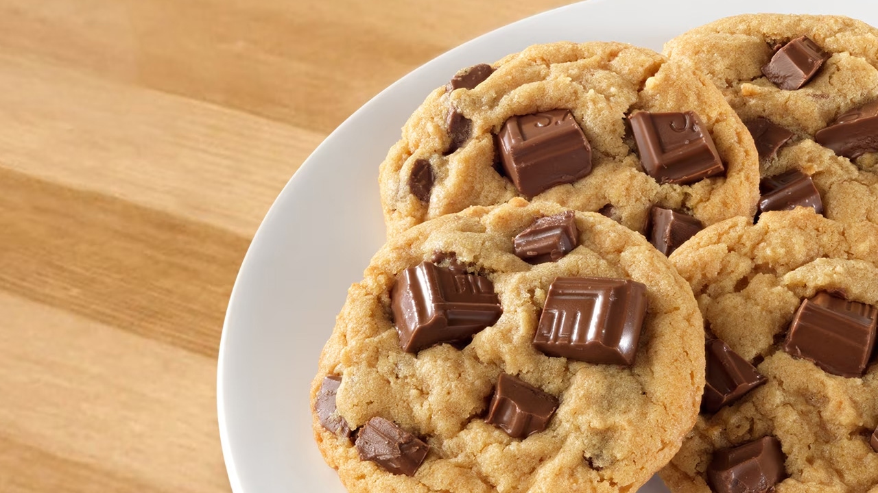 plate of cookies stuffed with chunks of a hersheys milk chocolate bar