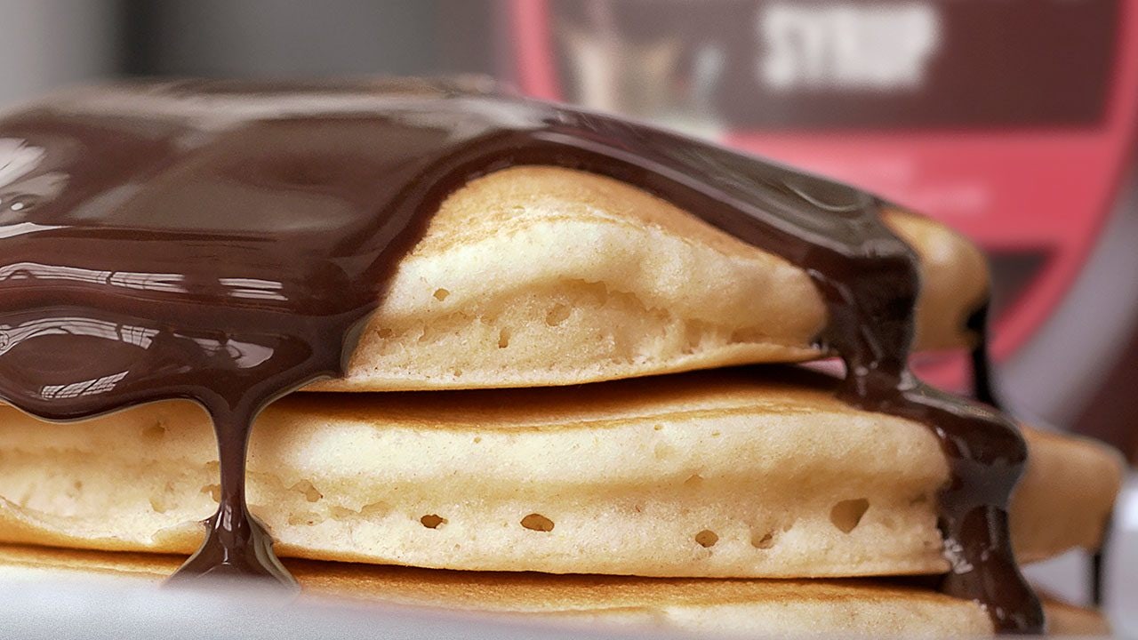 stack of pancakes topped with hersheys chocolate syrup