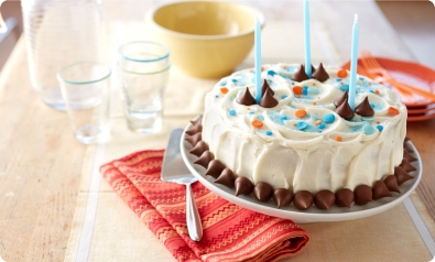 birthday cake on table with party plates