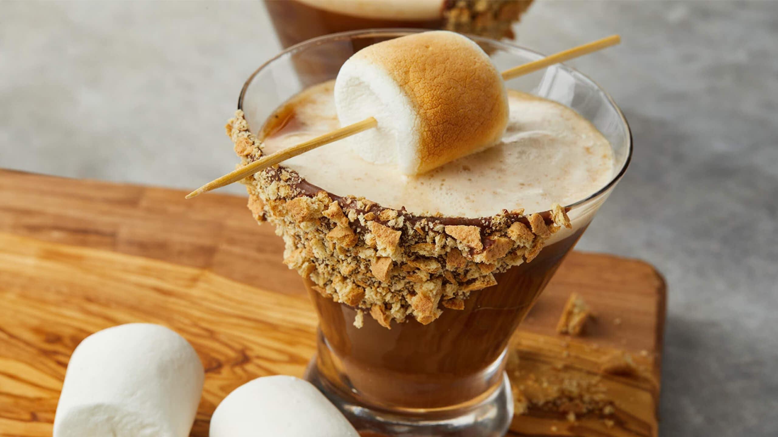 smores martini with toasted marshmallow garnish and crushed graham cracker rim