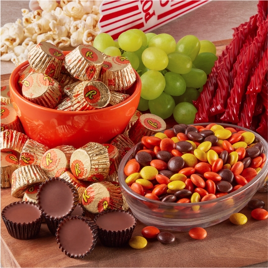 movie night snack tray with hersheys candies, grapes and popcorn